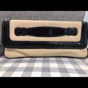 Beige and black clutch
